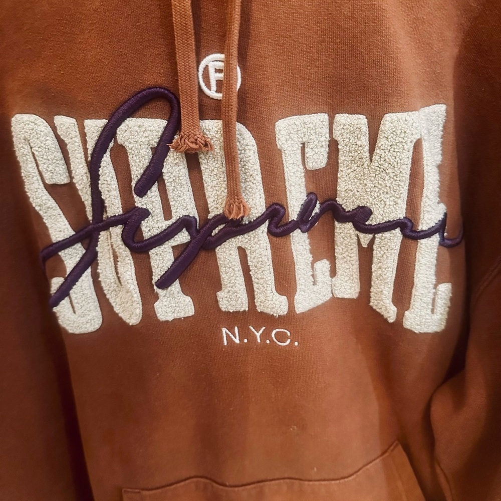 Supreme Men’s Brown Hoodie with tan and purple logos. Size L.